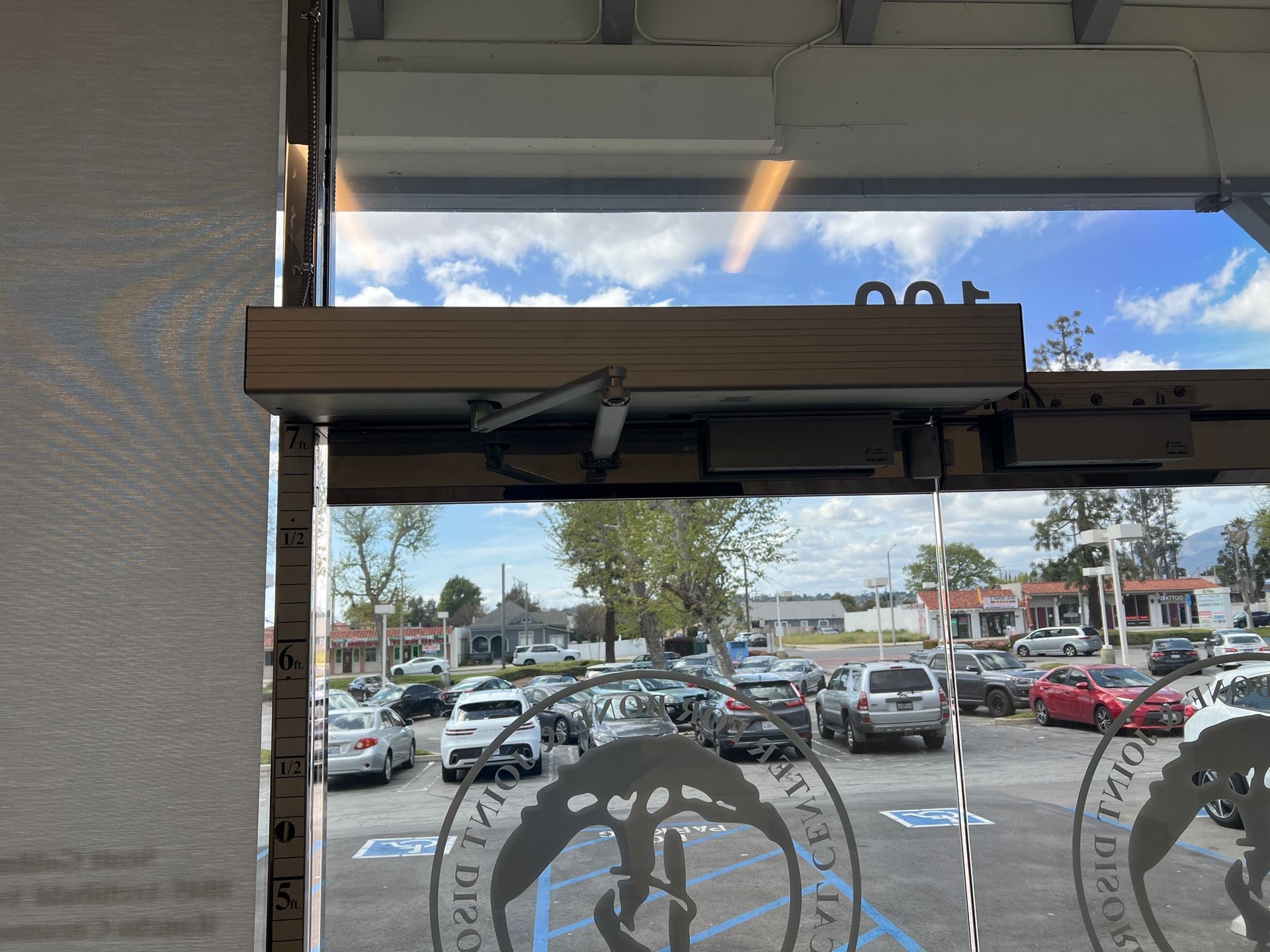 A view of a parking lot through a glass door.