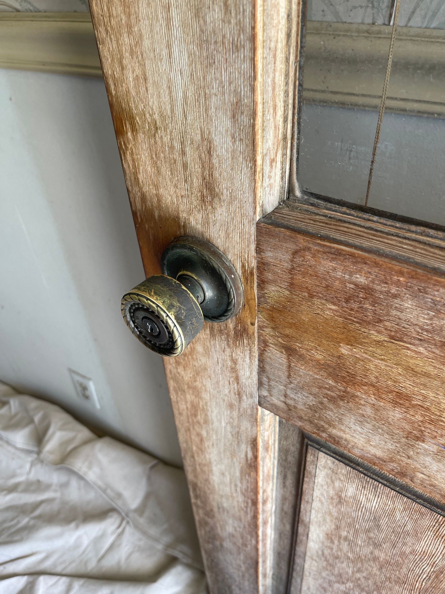 A close up of a door knob on a wooden door.
