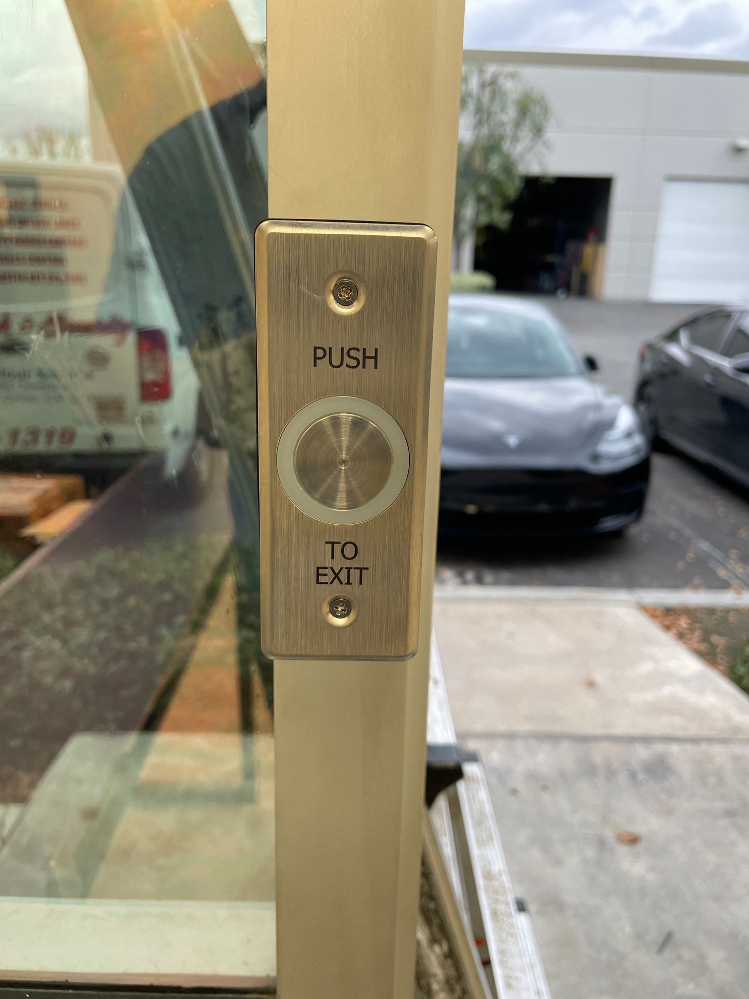 A close up of a push to exit button on a door.