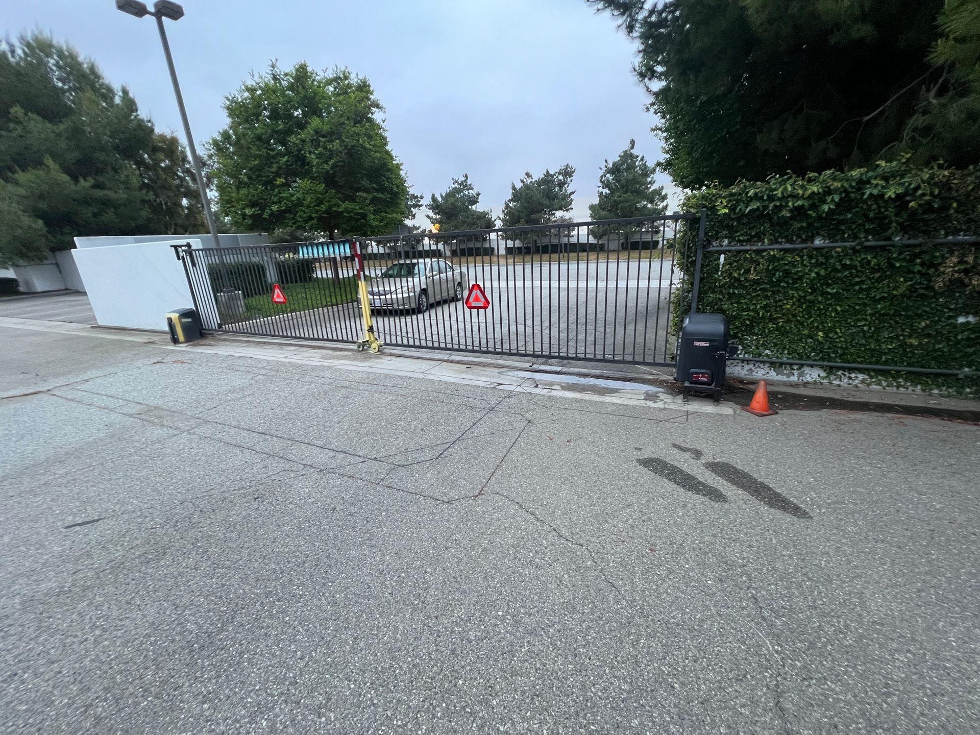 A broken gate is sitting on the side of the road.