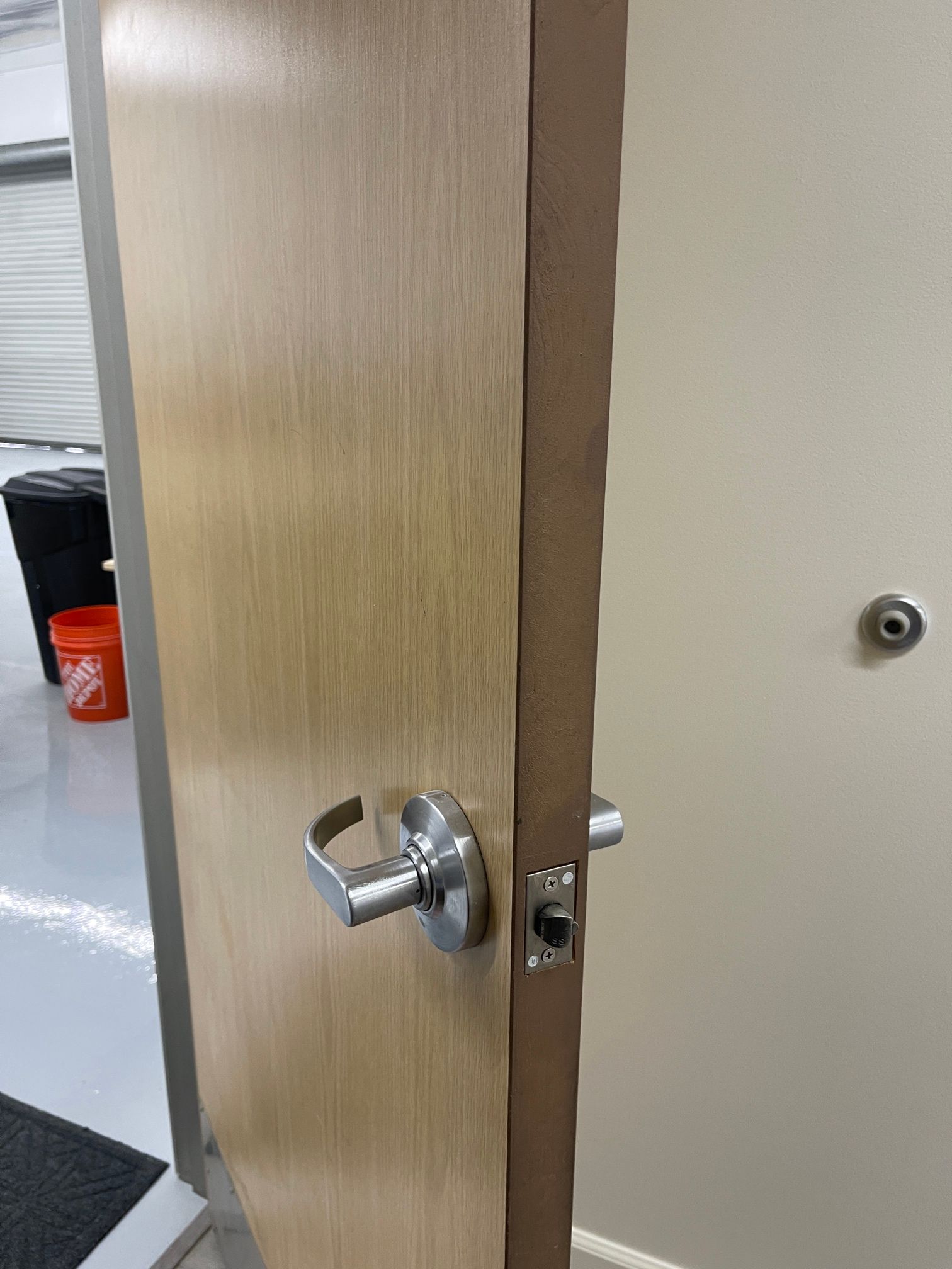A close up of a wooden door with a metal handle.