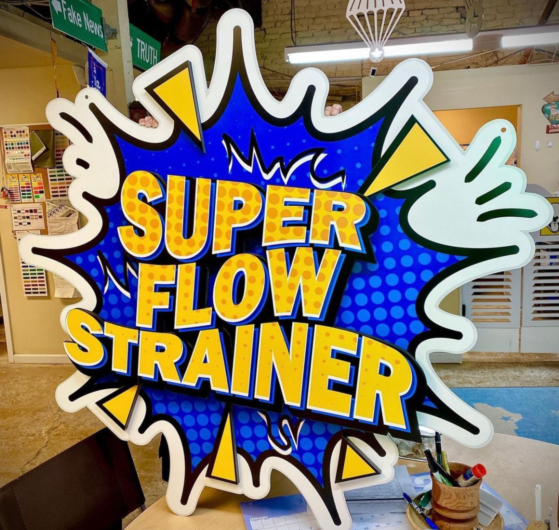 A sign that says super flow strainer on it