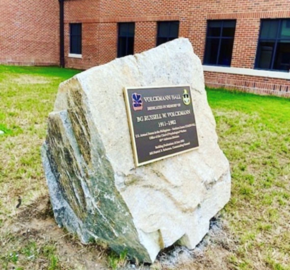 A large rock with a plaque on it that says veterans ball