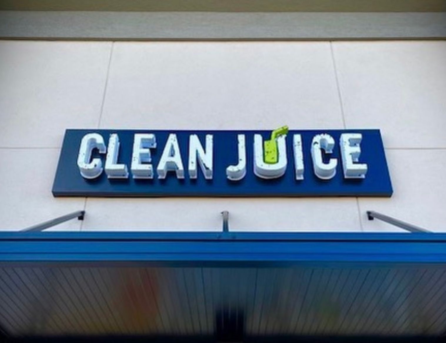A clean juice sign on the side of a building