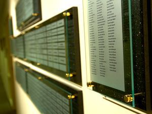 A row of plaques are hanging on a wall