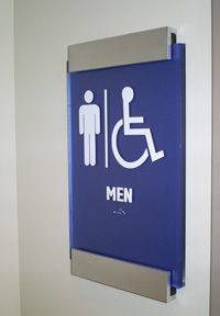 A blue sign for a men 's bathroom with a handicapped symbol on it.