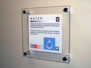 A sign on a wall that says water on it.