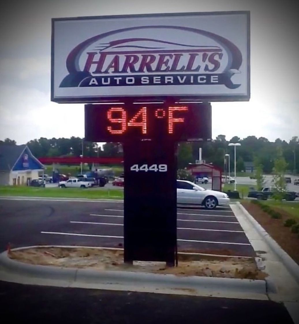 A harrell's auto service sign that says 94 degrees
