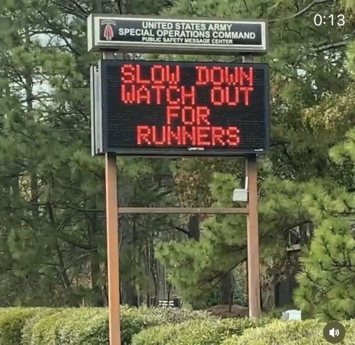 A sign that says slow down watch out for runners