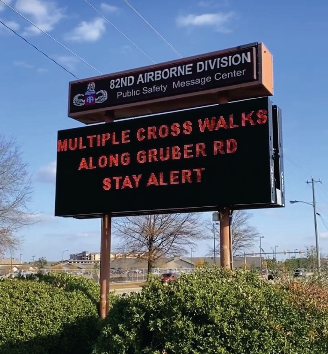 A sign that says multiple cross walks along gruber rd stay alert