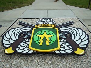 A sign that says airborne is on a sidewalk