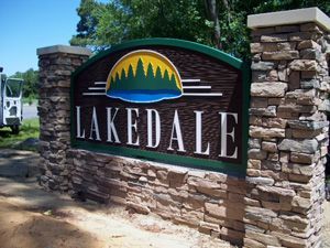 A sign for lakedale is carved into a stone wall