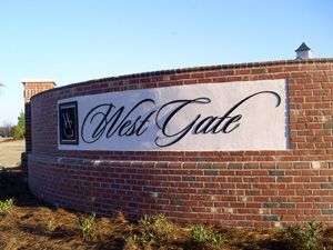 A brick wall with a sign that says west gale on it