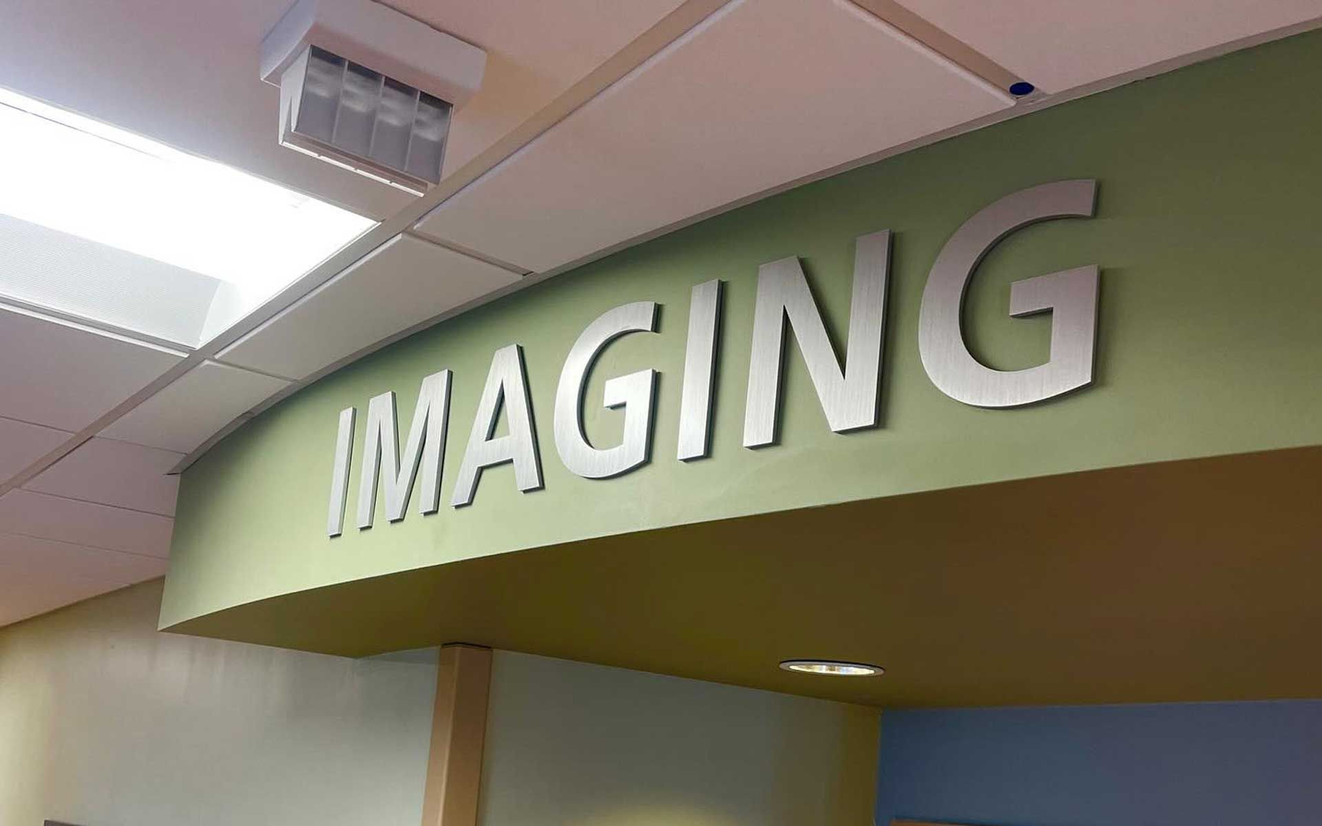 A green sign with the word imaging on it