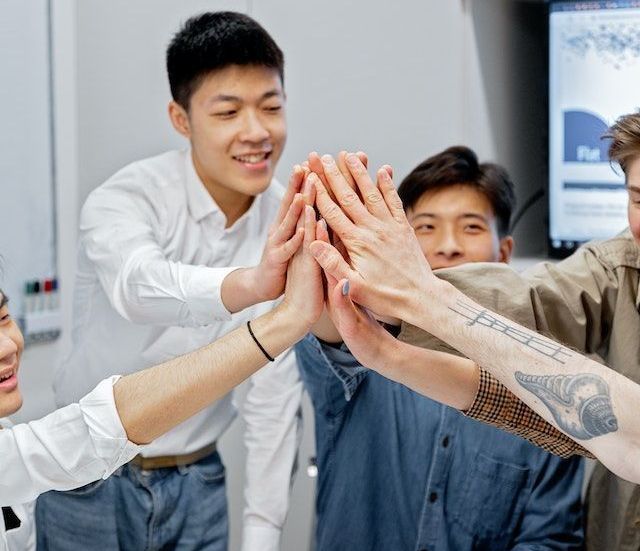 During a meeting, coworkers share a high 5