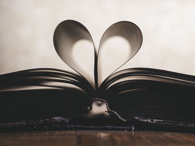 An image of pages of a book bent into the shape of a heart