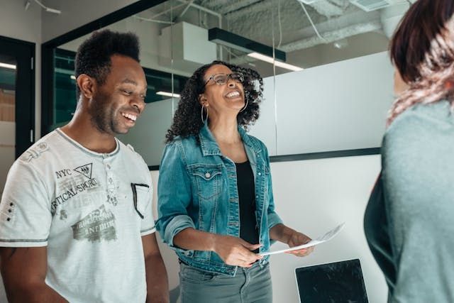 Colleagues laugh during an informal meeting