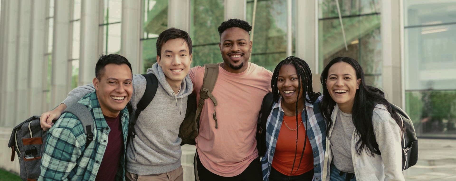 A diverse group of college students smile at the camera