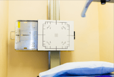 X-ray machine beside a hospital bed in a clinical room