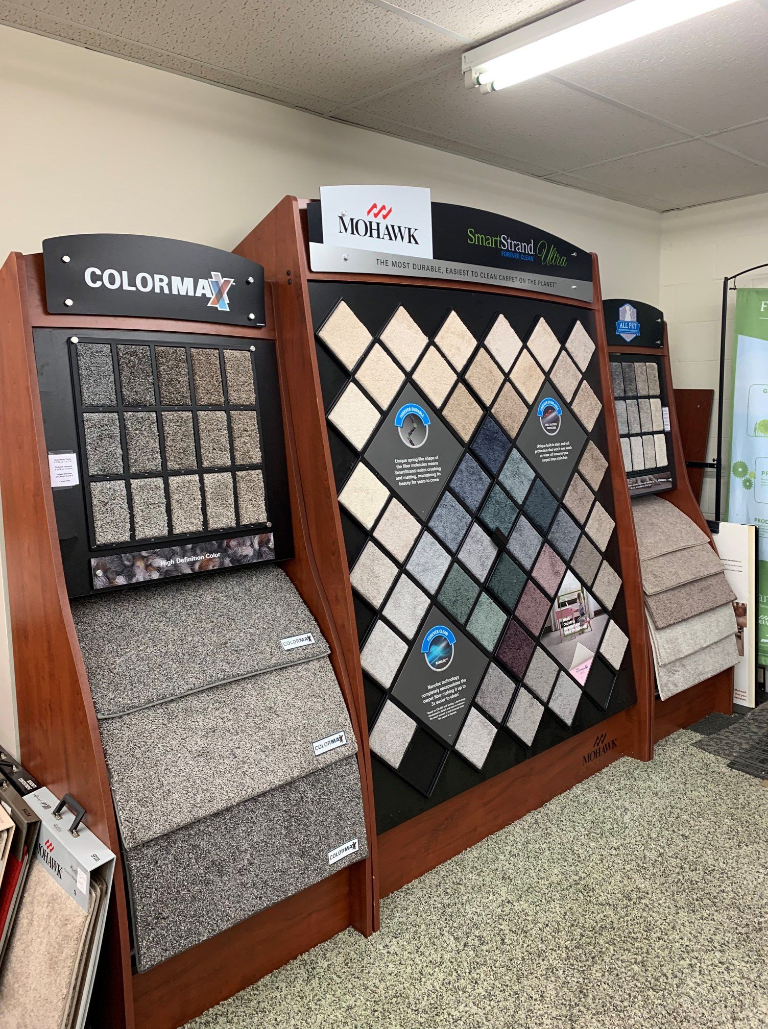Carpet sample display in a showroom, showcasing various colors and textures.