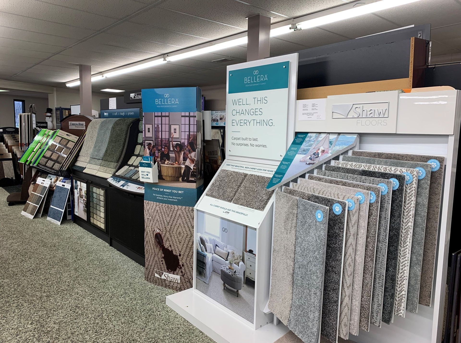 Carpet store display with samples in various colors and textures.