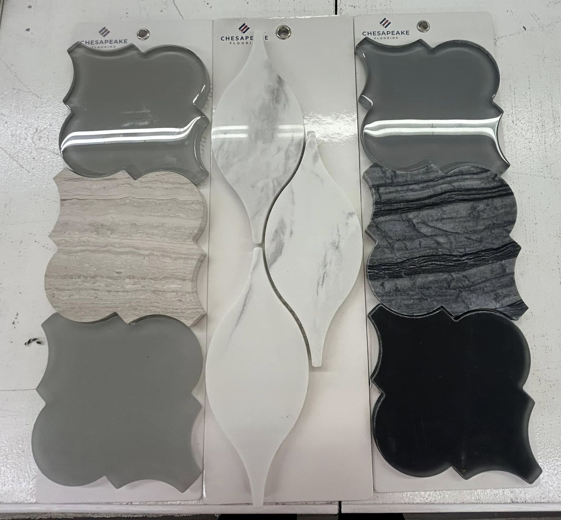 Tile samples in gray, white, and black with unique shapes.