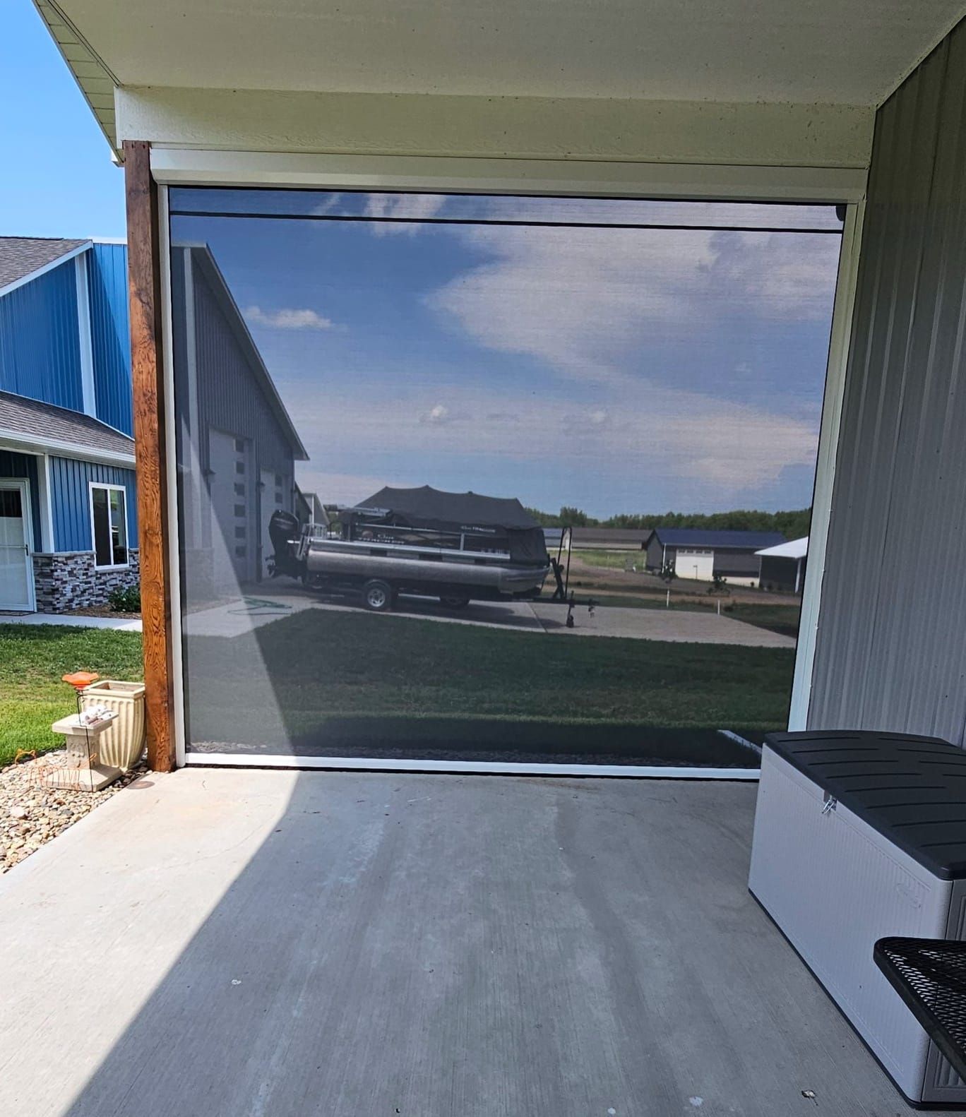 A screened in porch with a truck parked in front of it