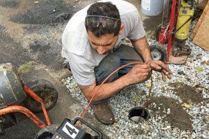 Plumber working on sewer line - TLC Plumbing