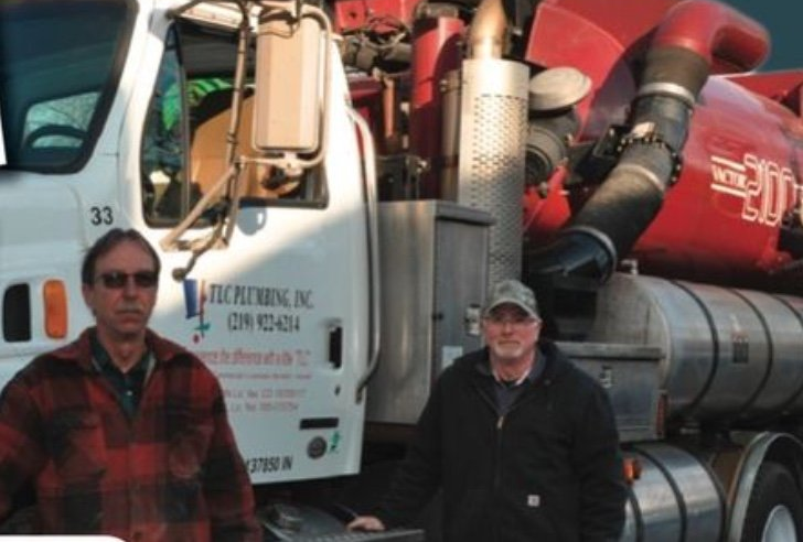 Plumbers in front of truck - TLC Plumbing