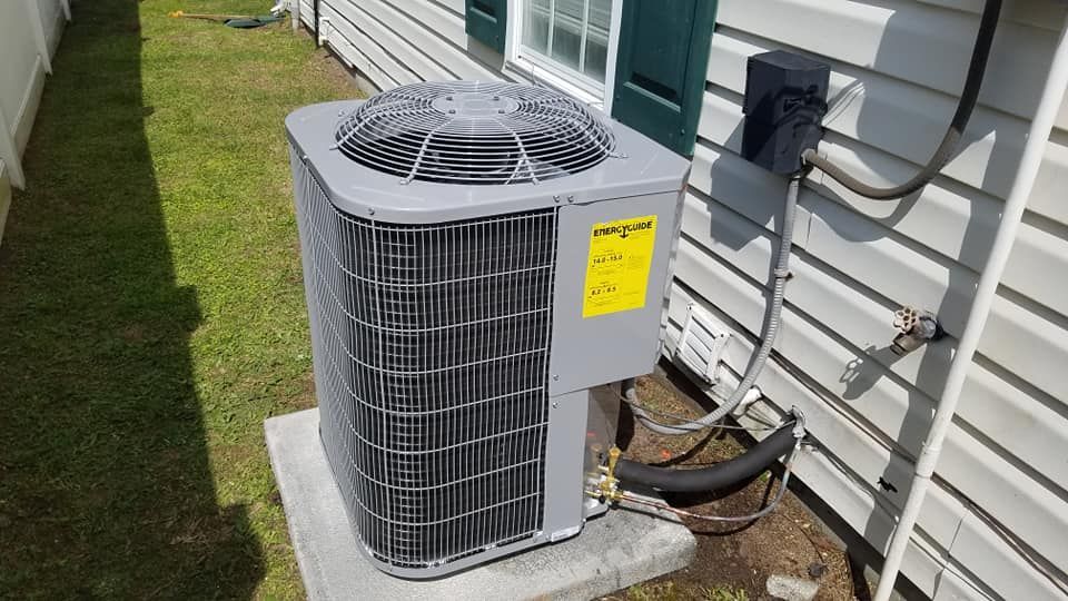An air conditioner is sitting on the side of a house