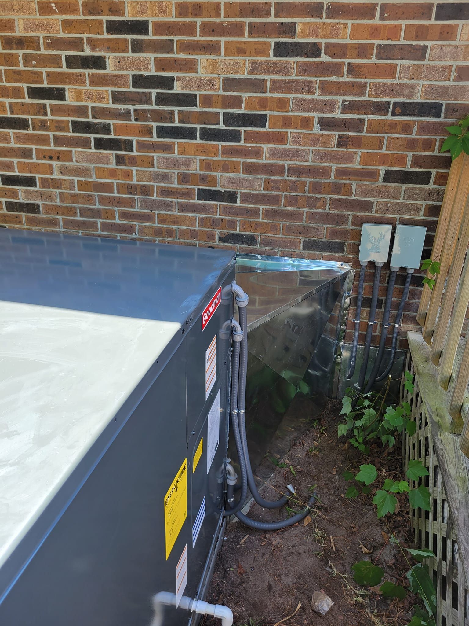 A brick wall with a hose coming out of it next to a pool