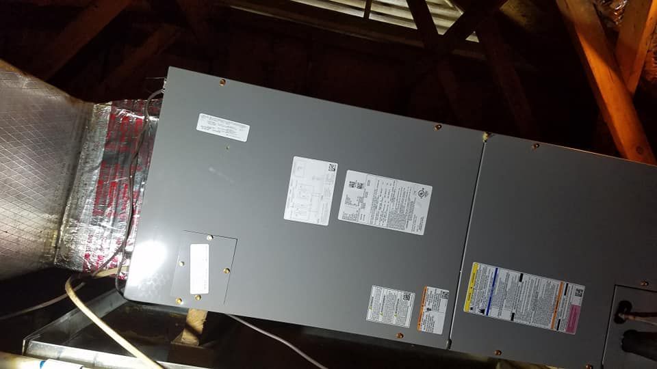 An air conditioner is sitting in the attic of a house