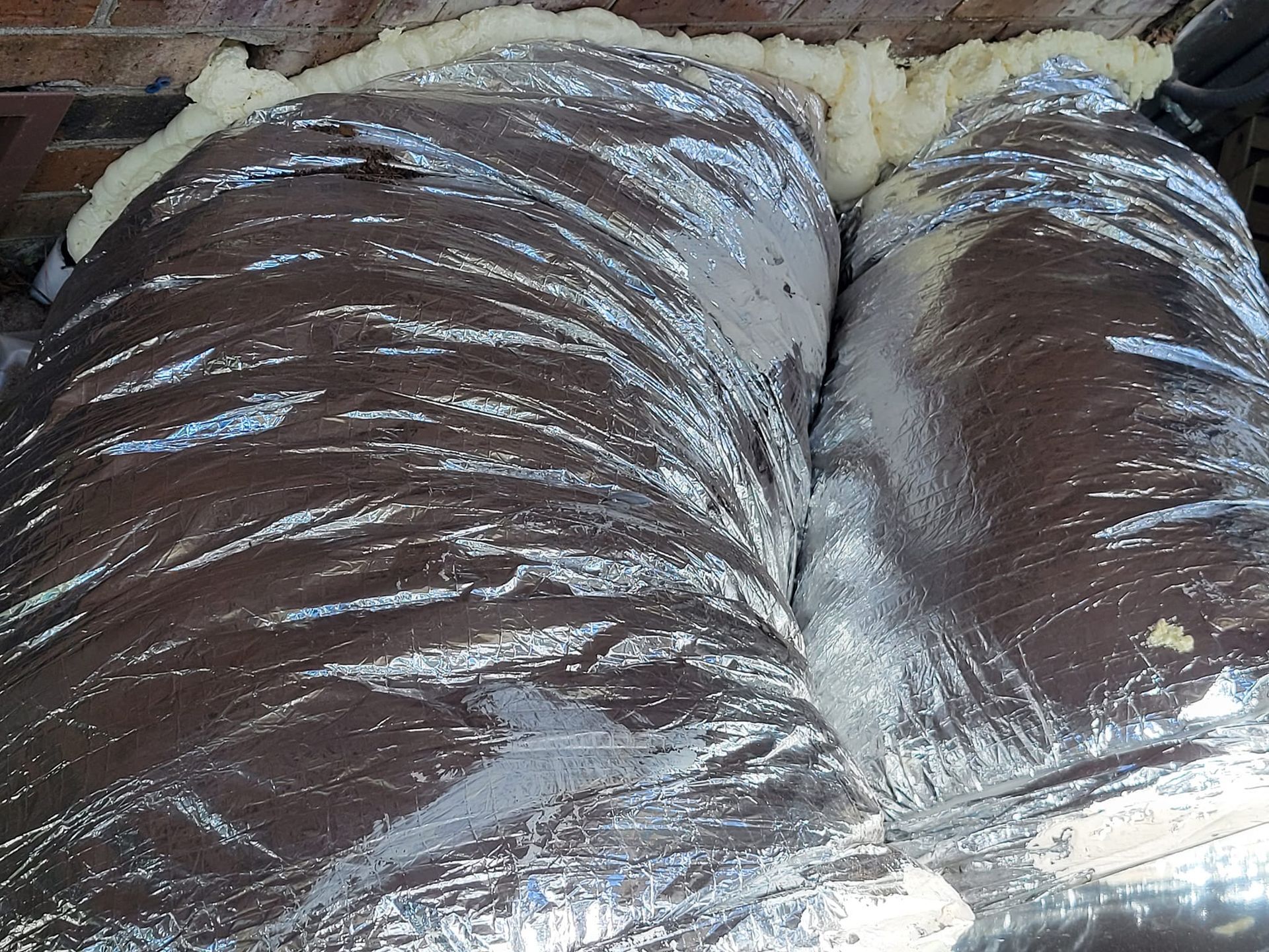 A close-up of a duct with insulation on it