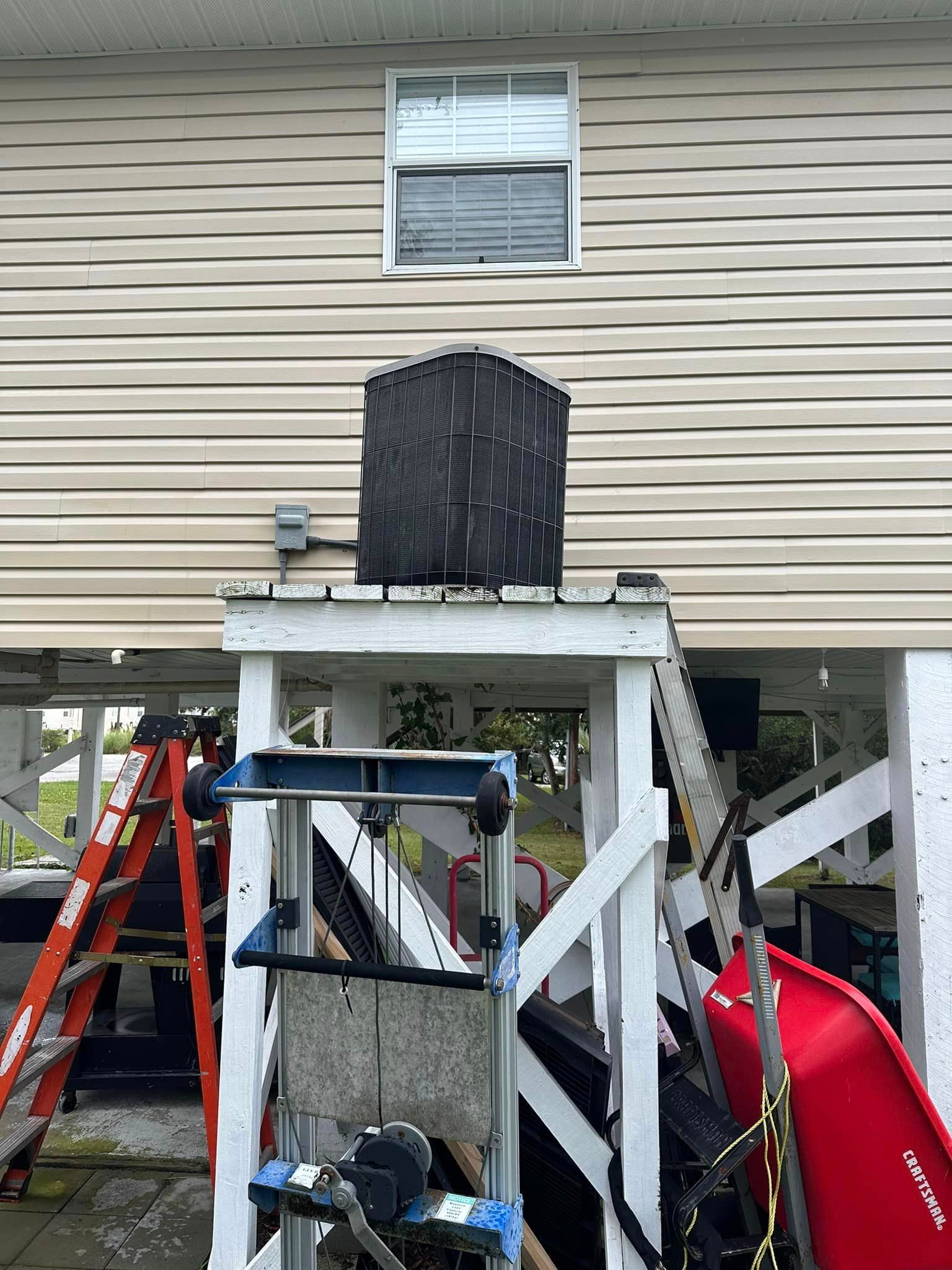 A house with a slide and a ladder in front of it