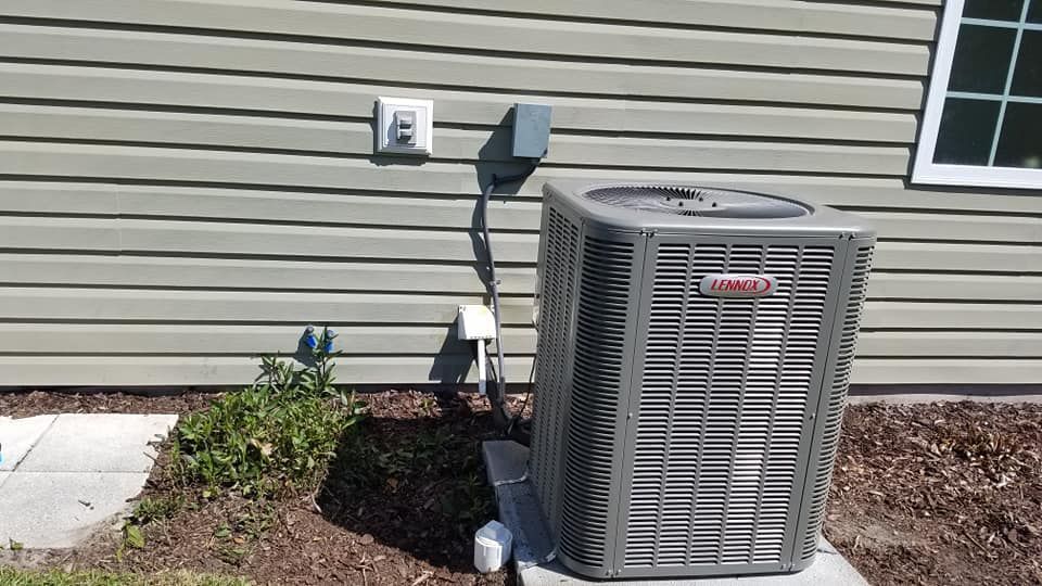 A lennox air conditioner is sitting outside of a house