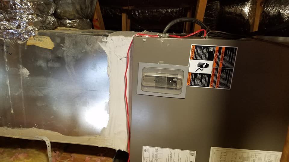 A refrigerator is sitting in the attic of a house