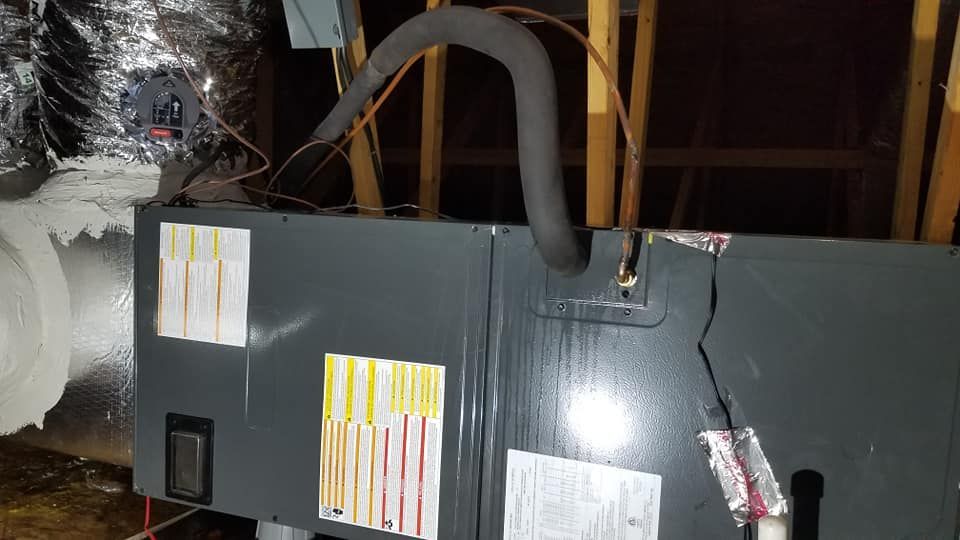 A black box with a hose attached to it is sitting in a dark room