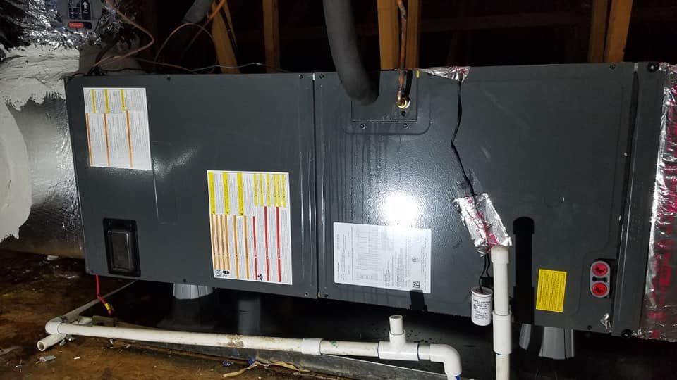 An air conditioner is sitting in the attic of a house