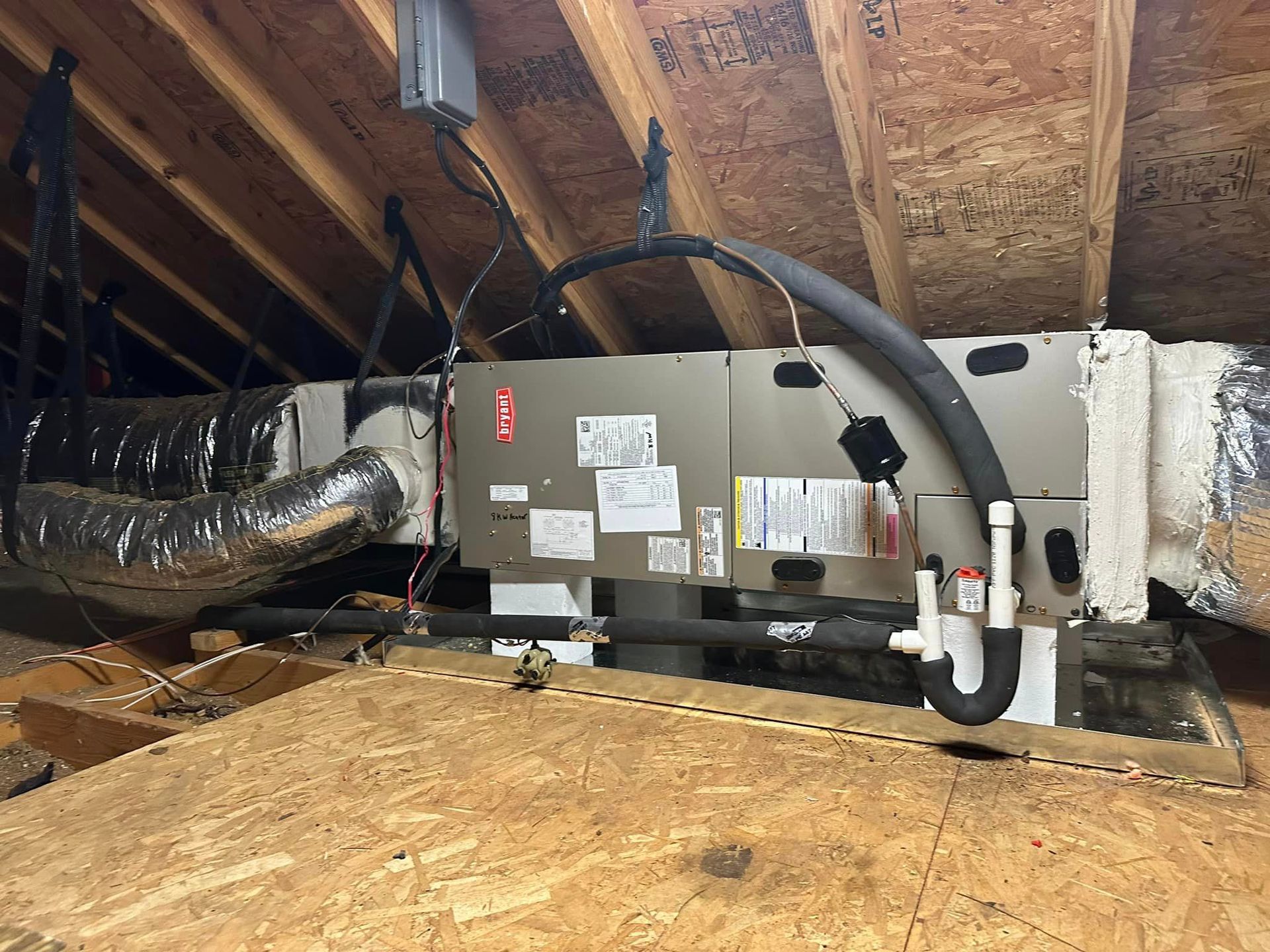 An air conditioner is installed in the attic of a house