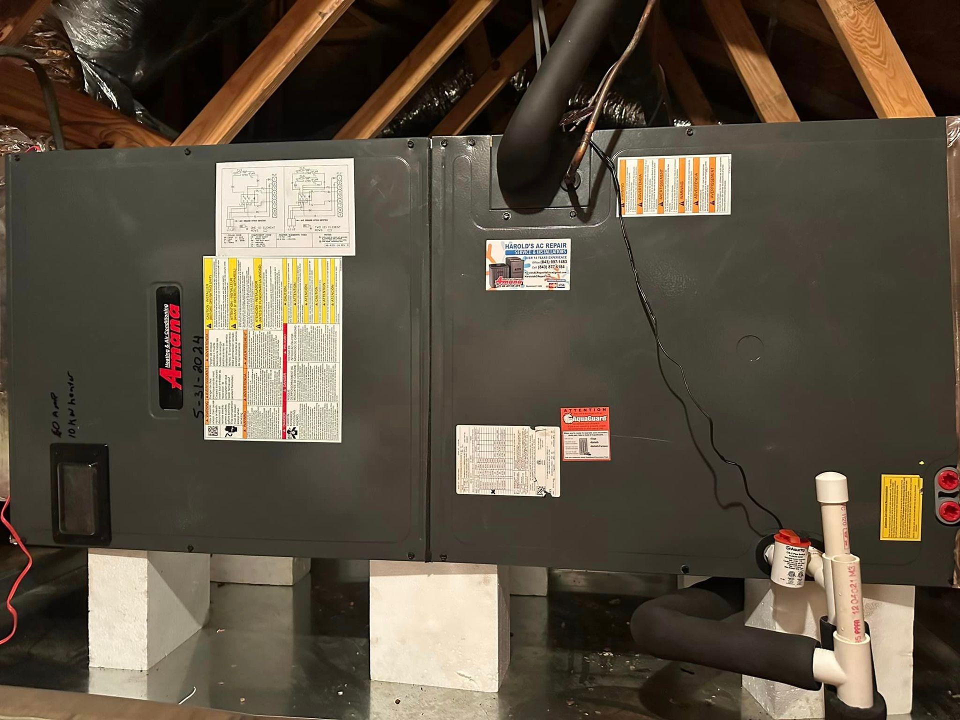 An air conditioner is sitting in the attic of a house