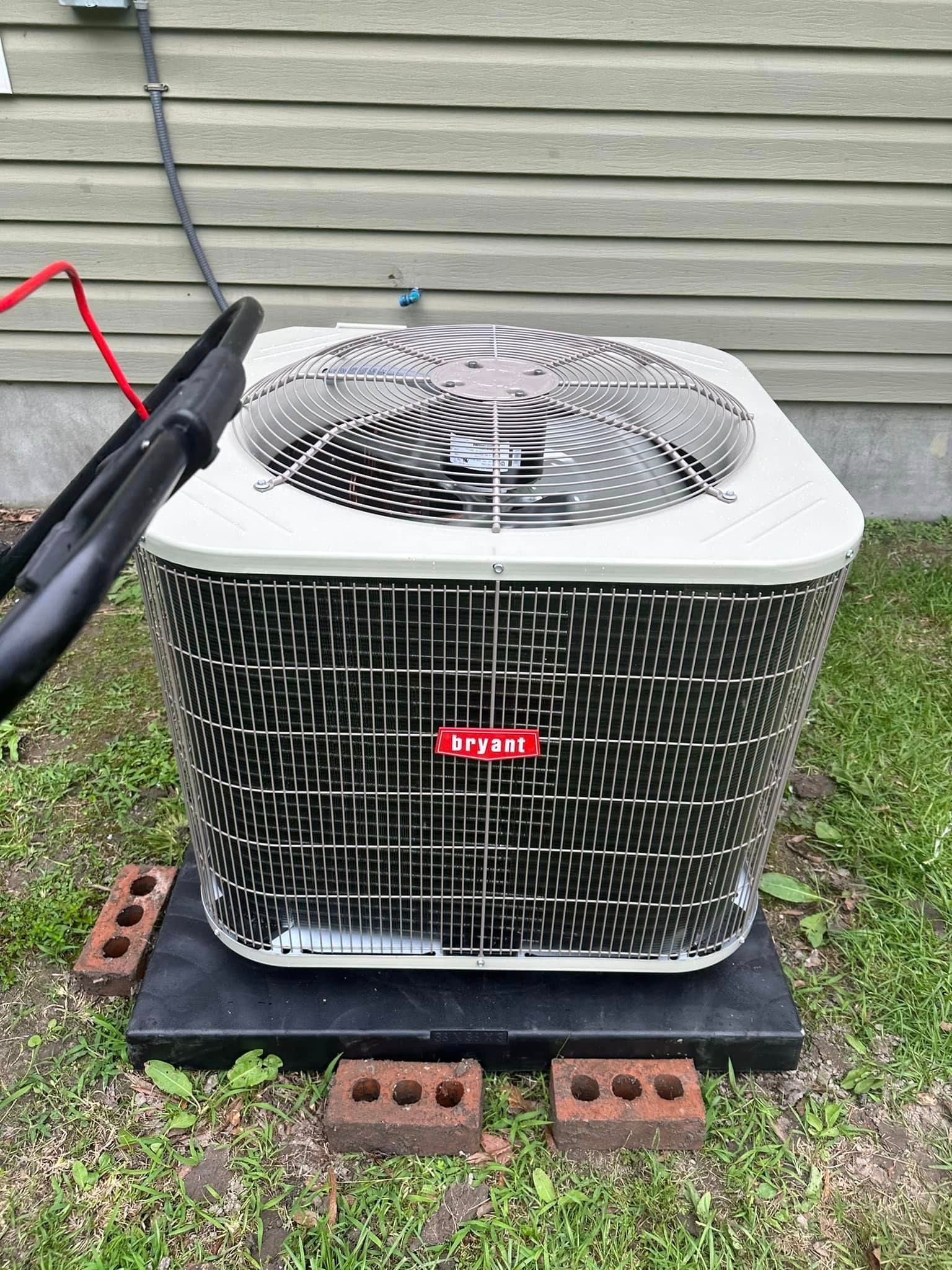 A large air conditioner sits on top of a black platform