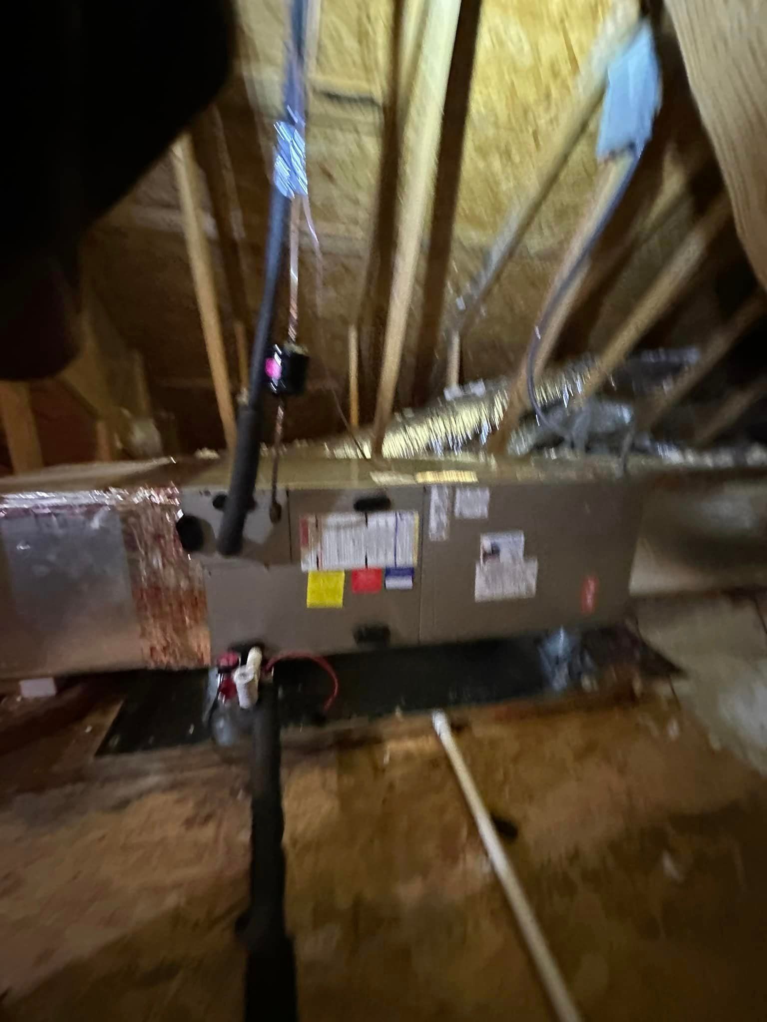 A picture of an air conditioner in an attic
