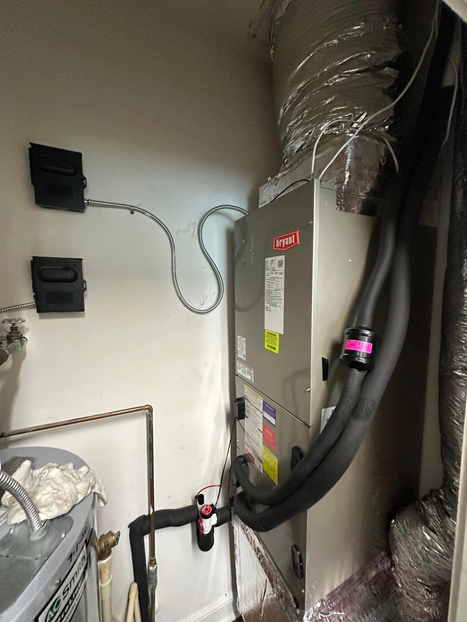 A room with a furnace and a bunch of wires coming out of it