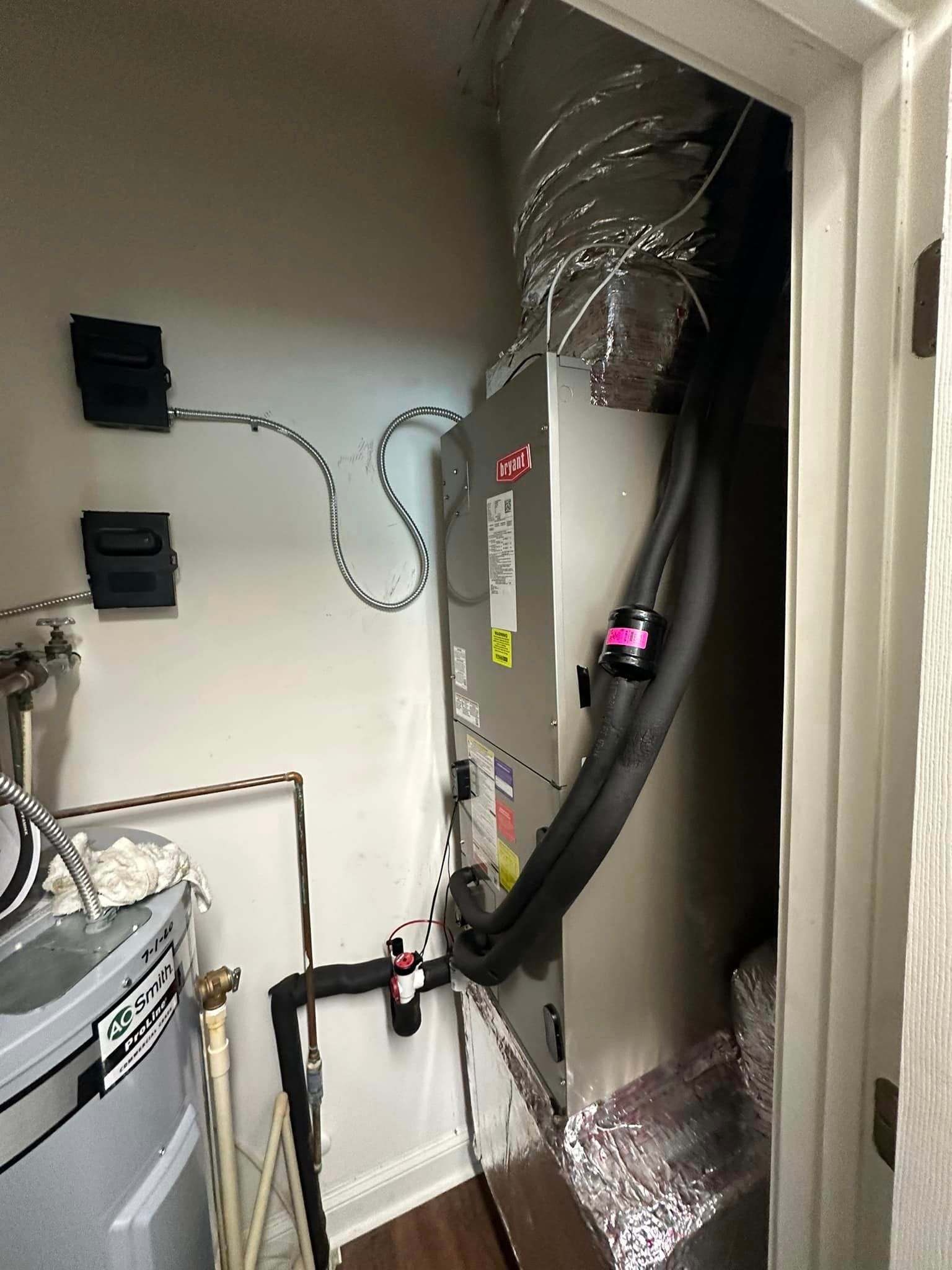 A room with a furnace and a water heater in it.