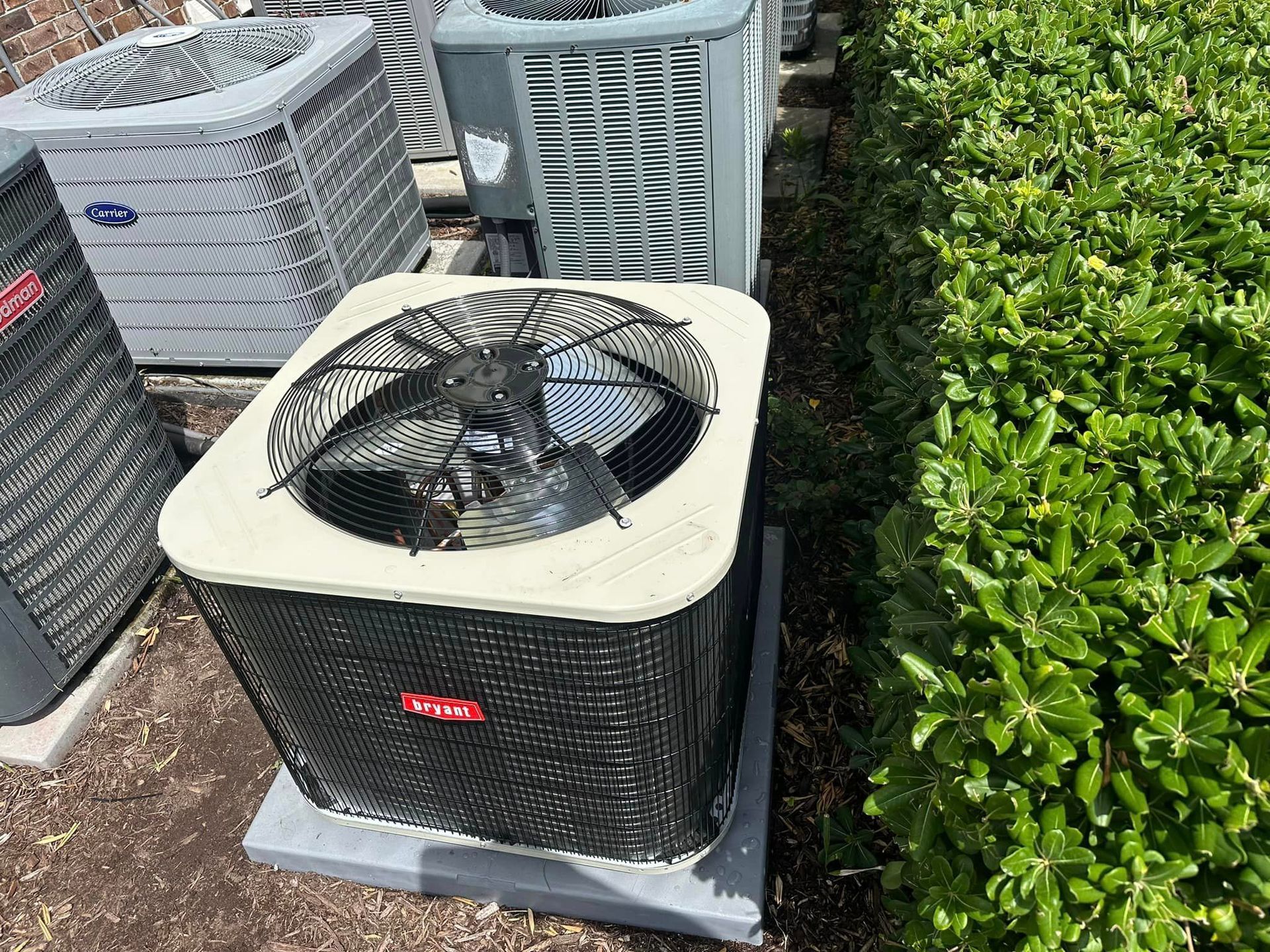 A bunch of air conditioners are sitting next to each