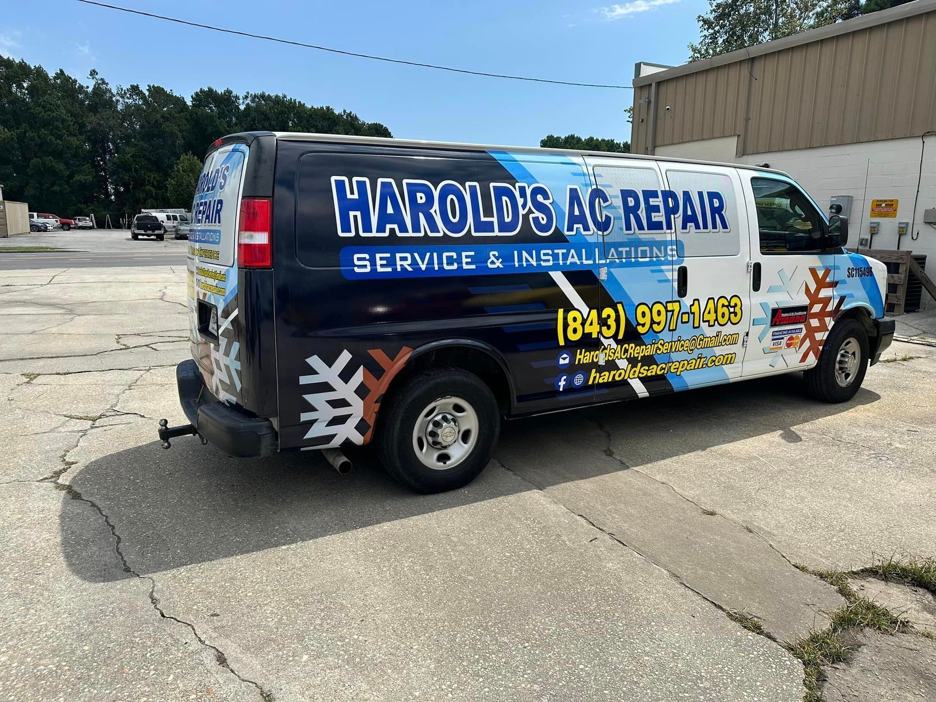 A Harold's Ac repair van is parked in a parking lot