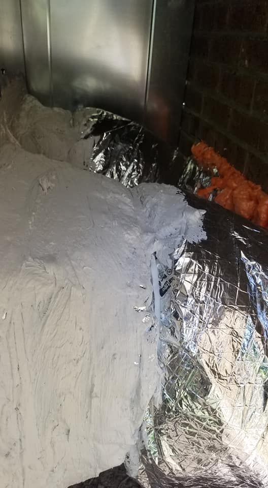 A close up of a duct with aluminum foil on it