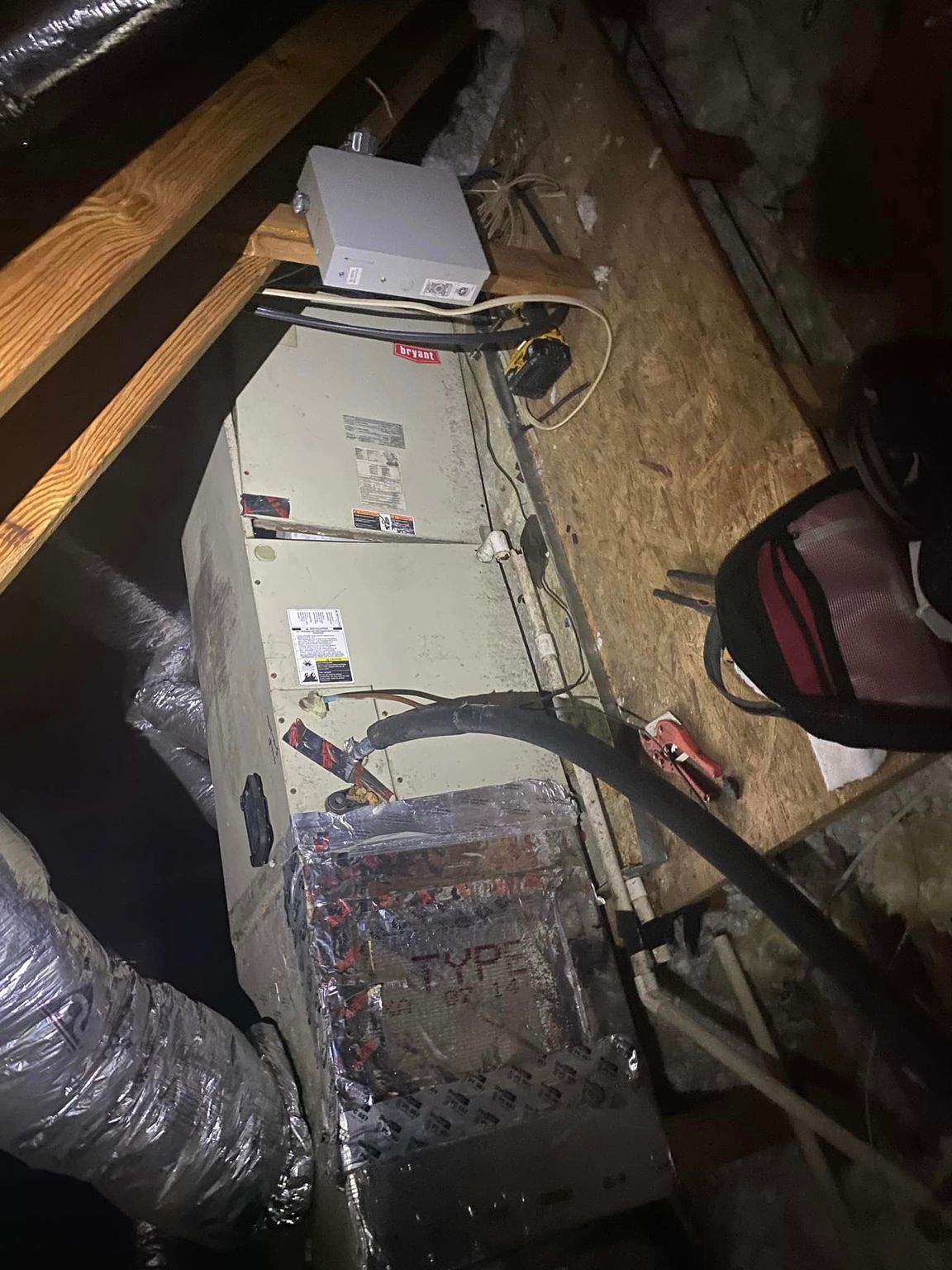 A box is sitting on top of a wooden table in a dark room