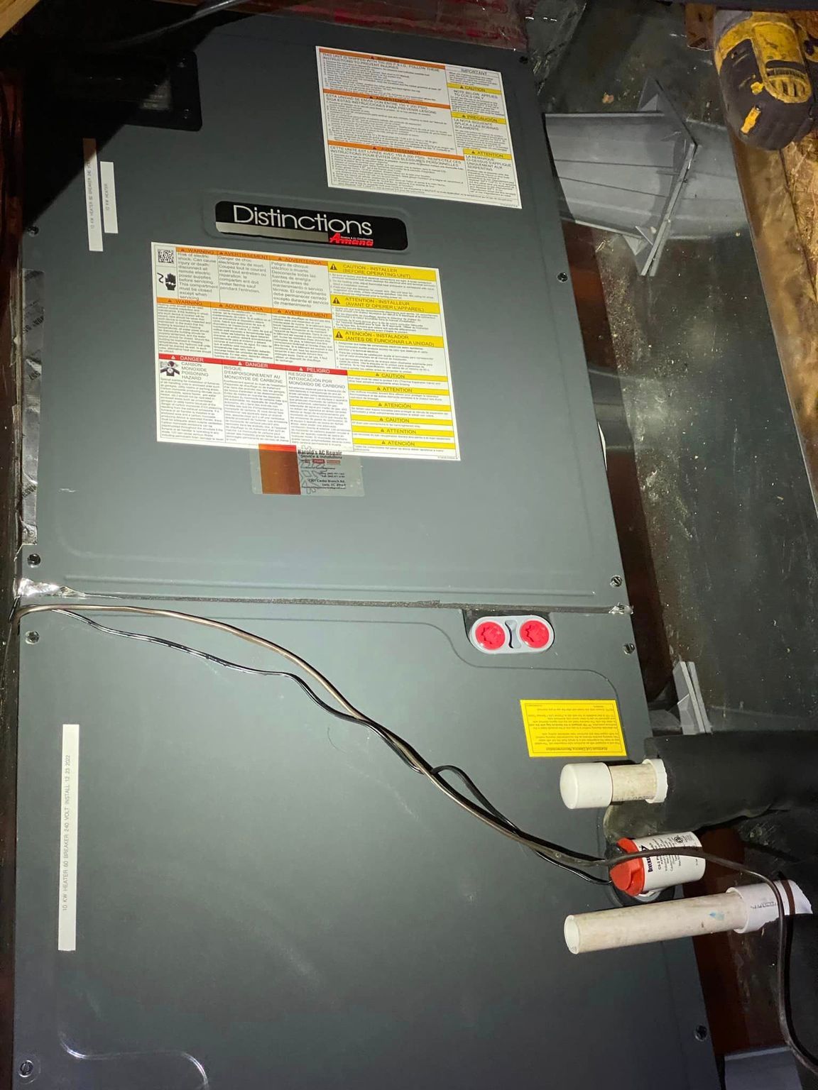 An air conditioner is sitting on top of a wooden table