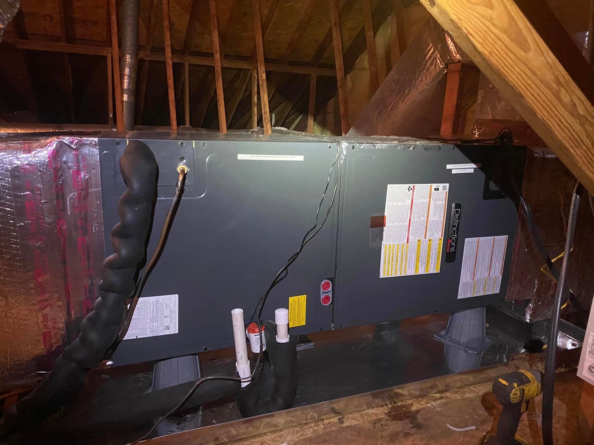 An air conditioner is sitting in the attic of a house